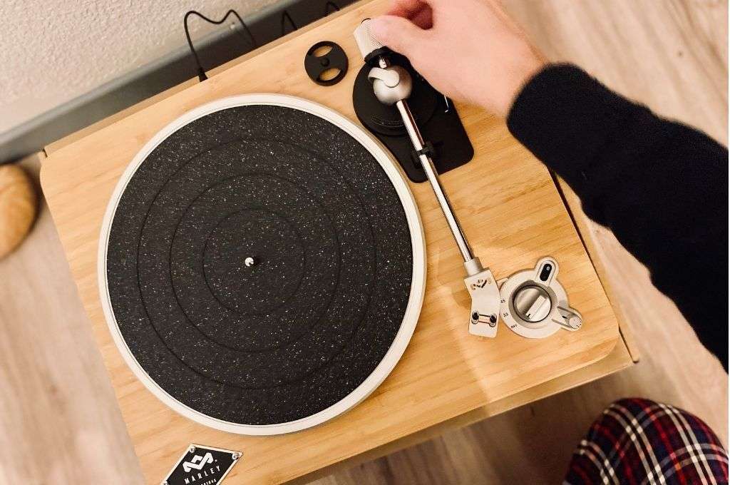 A man listening to a manual turntable