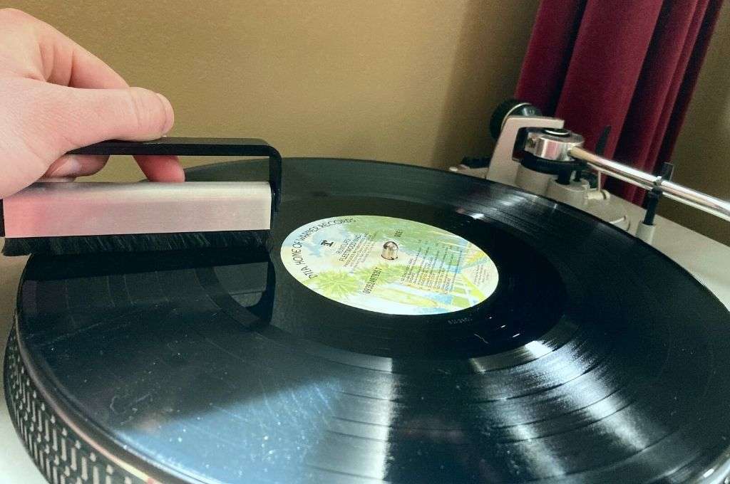 Man cleaning a record