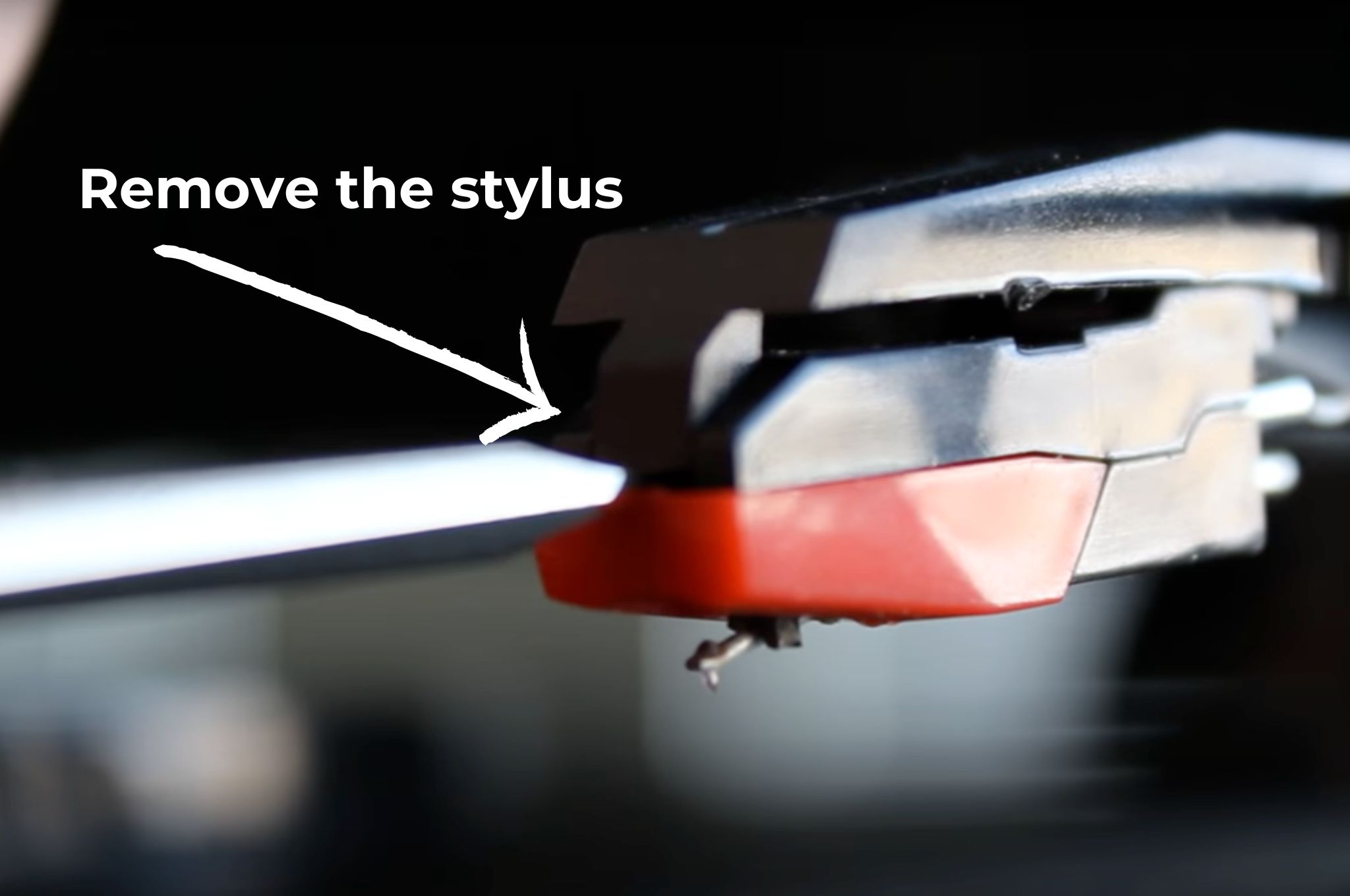 Removing the old stylus from a record player's headshell